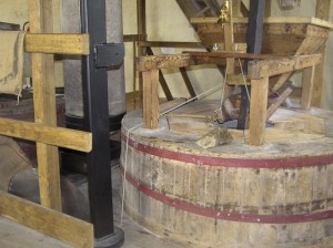 The milling set up, as normally seen during a visit to the mill, with the stones enclosed by wooden casings and hoppers